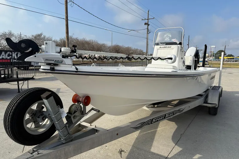 Slide: The Image of 2017 Blazer Bay 2200 boat on trailer, featuring Minn Kota trolling motor. - 4
