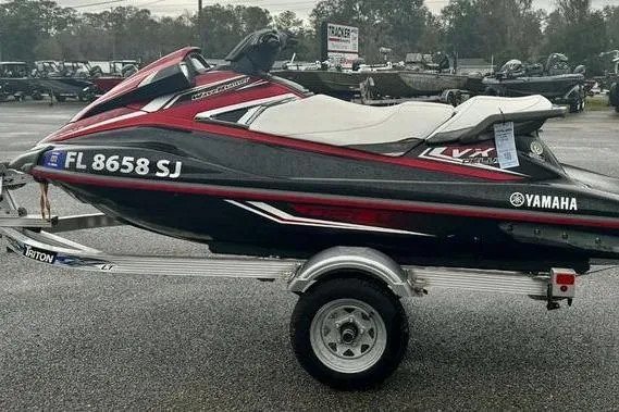 The Image of 2016 Yamaha WaveRunner VX Deluxe on trailer, red and black design, parked outdoors. - 0