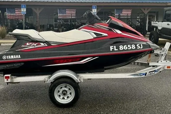Slide: The Image of 2016 Yamaha WaveRunner VX Deluxe on trailer, black and red design, parked outdoors. - 4