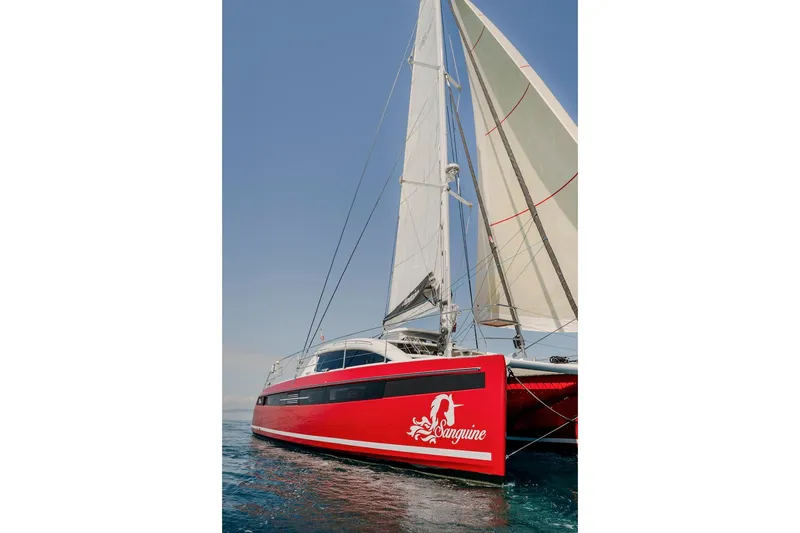 Slide: The Image of Privilege Signature 510 catamaran, 2025 model, docked in harbor. - 2