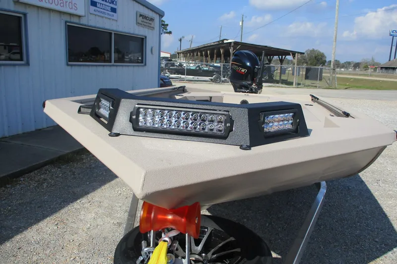 Slide: The Image of 2026 Avid 18 Commander boat with LED lights, parked outside a marine dealership. - 2