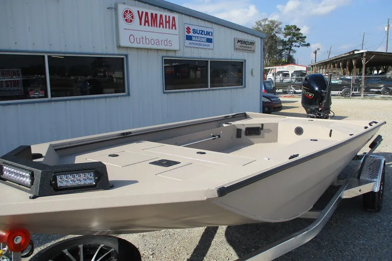 Slide: The Image of 2026 Avid 18 Commander boat on trailer outside Yamaha dealership. - 3