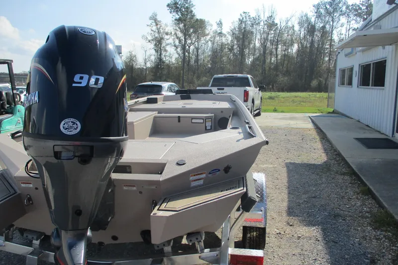 Slide: The Image of 2026 Avid 18 Commander boat with Yamaha 90 engine, parked outdoors. - 5