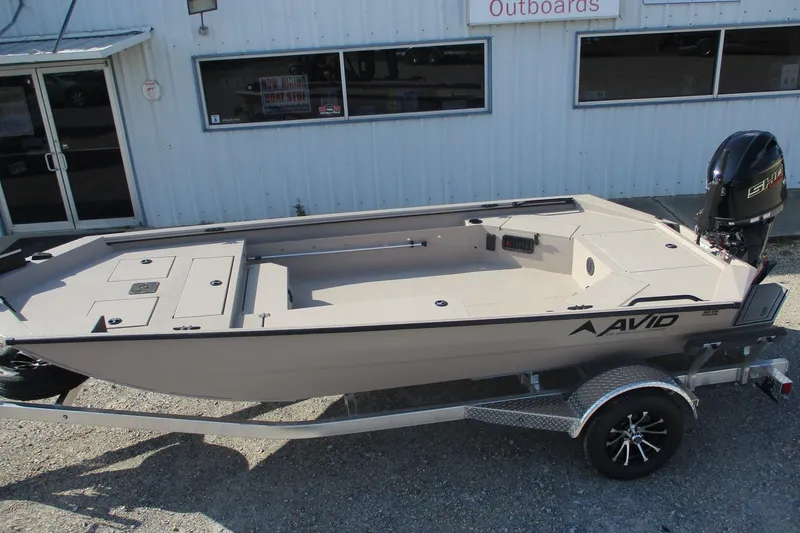 Slide: The Image of 2026 Avid 18 Commander boat on trailer outside dealership. - 6