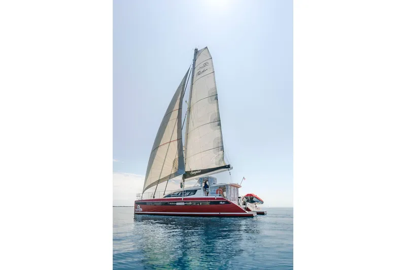 Slide: The Image of 2025 Privilege Signature 510 catamaran on calm waters. - 8