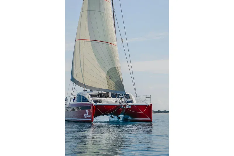 Slide: The Image of Red Privilege Signature 510 catamaran sailing on calm waters, 2025 model. - 78