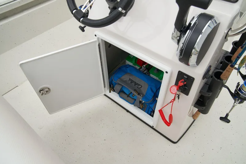 Slide: The Image of Manufacturer Provided Image: 2025 Ranger RB210 boat storage compartment with open door, showing organized gear and fishing equipment. - 34