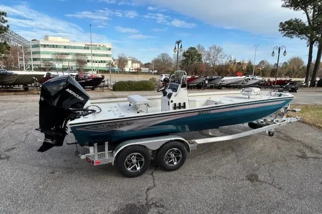Slide: The Image of 2025 Ranger RB210 boat on trailer, parked outdoors with buildings in the background. - 4