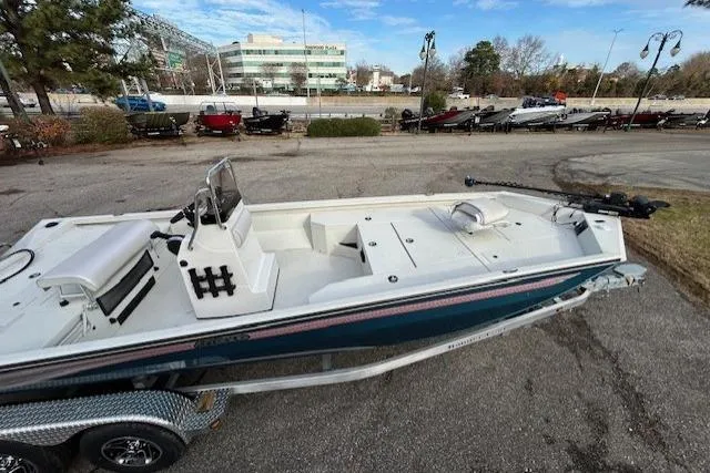 Slide: The Image of 2025 Ranger RB210 boat on trailer, parked outdoors, showcasing sleek design and spacious deck. - 6