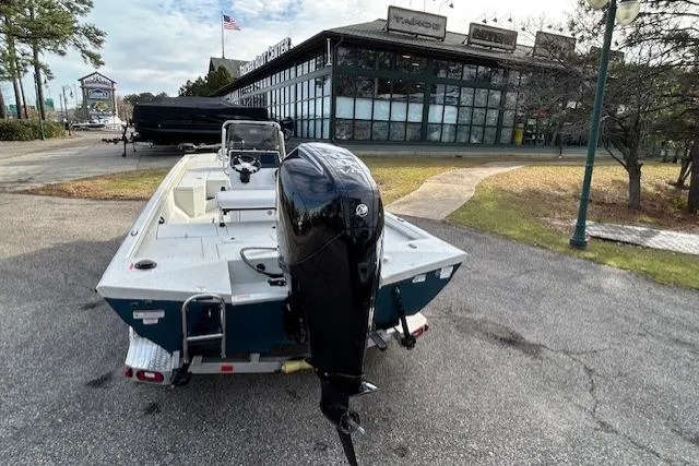 Slide: The Image of 2025 Ranger RB210 boat with outboard motor parked near a dealership. - 7