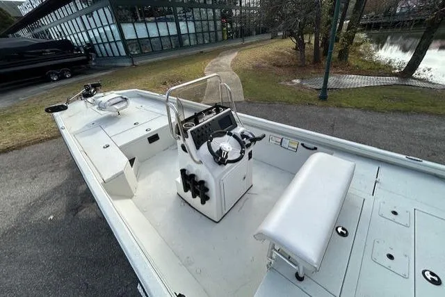 Slide: The Image of 2025 Ranger RB210 boat with sleek interior design, parked near a modern building. - 8