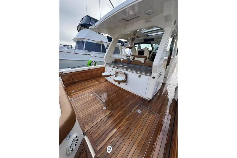 Slide: The Image of 2020 Scout 530 LXF luxury yacht with sleek wooden deck and modern seating. - 10