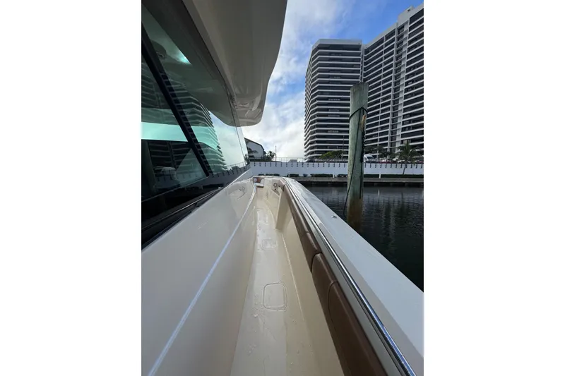 Slide: The Image of Luxurious seating area on a 2020 Scout 530 LXF boat with elegant wood tables. - 15