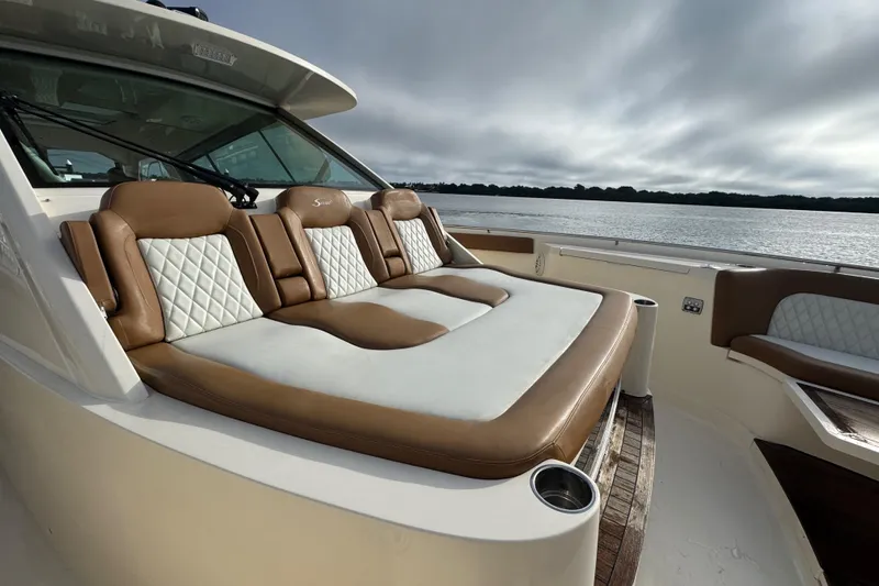 Slide: The Image of Side view of 2020 Scout 530 LXF yacht docked near waterfront buildings. - 20