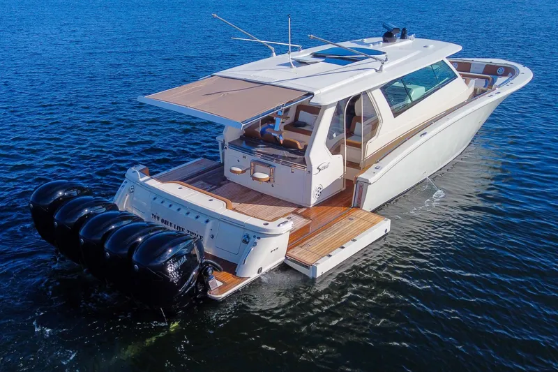 Slide: The Image of 2020 Scout 530 LXF luxury boat with four outboard engines on open water. - 3