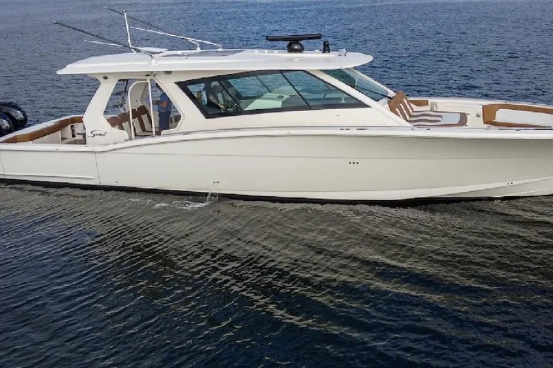 Slide: The Image of 2020 Scout 530 LXF luxury boat cruising on open water. - 4