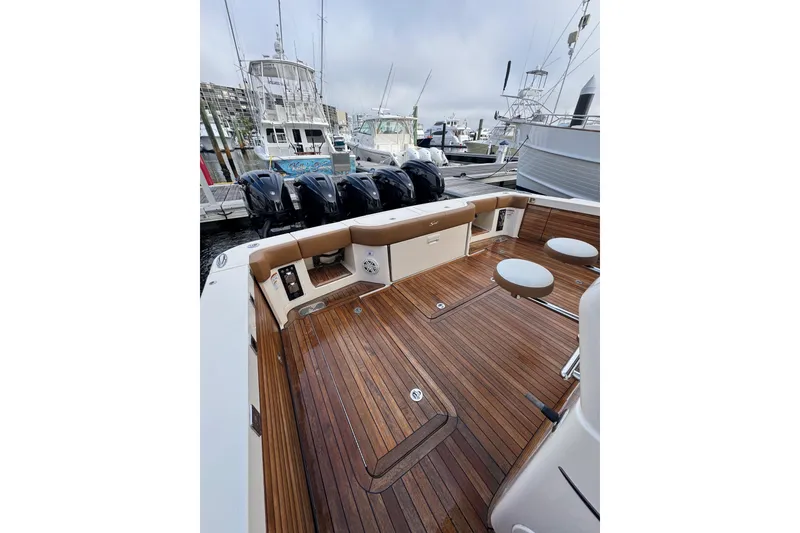 Slide: The Image of 2020 Scout 530 LXF boat with teak deck and multiple outboard engines. - 8