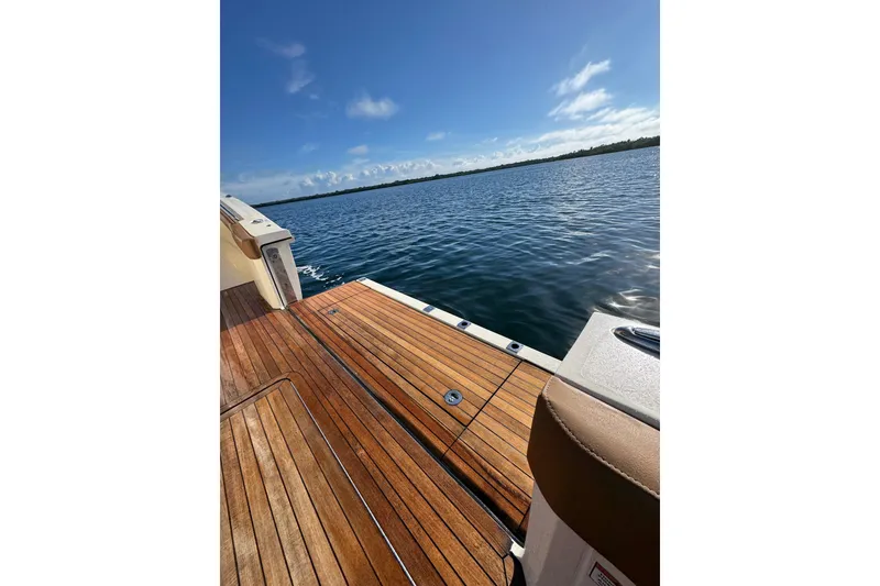 Slide: The Image of 2020 Scout 530 LXF boat deck with ocean view under clear blue sky. - 9