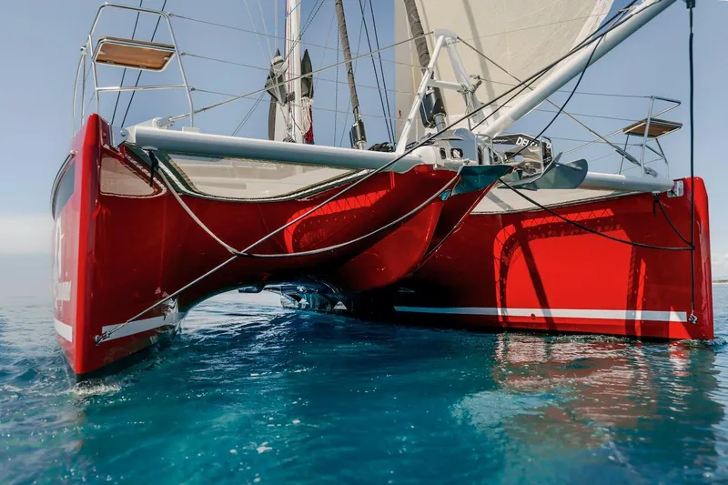 Slide: The Image of Red Privilege Signature 510 catamaran on clear water, year 2025. - 69