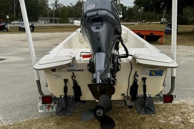 Slide: The Image of 2015 Carolina Skiff JV17CC boat with outboard motor, rear view in outdoor setting. - 3