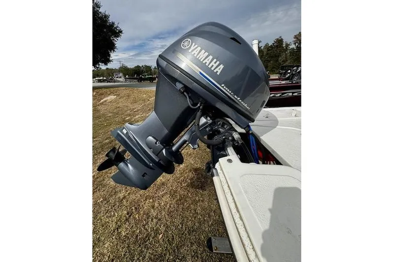 Slide: The Image of 2015 Carolina Skiff JV17CC with Yamaha outboard motor on grassy shore. - 4