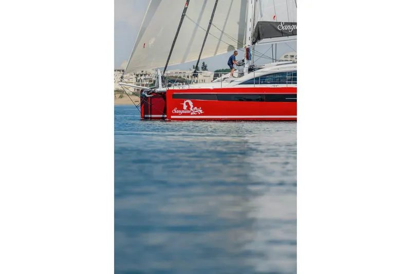 Slide: The Image of Red Privilege Signature 510 sailboat on calm water, year 2025. - 74