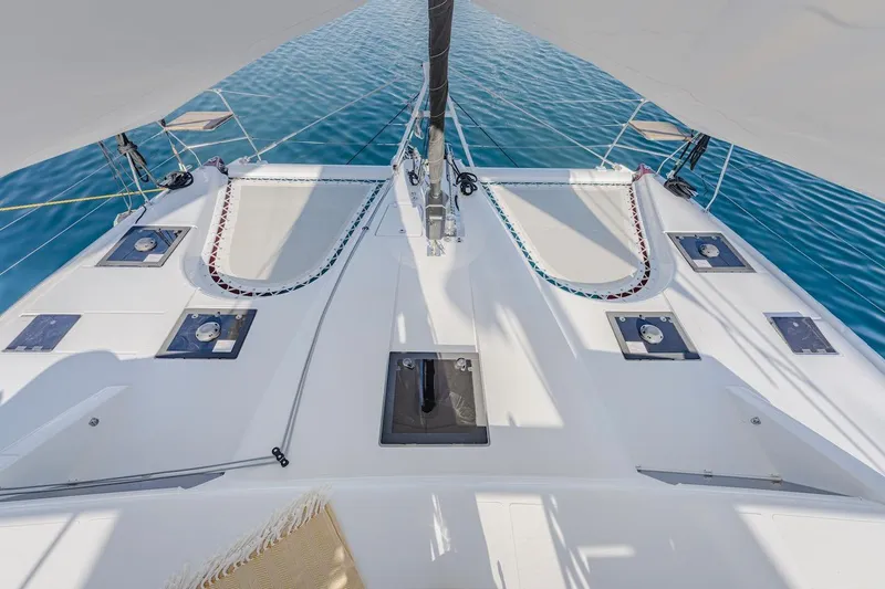 Slide: The Image of Deck of Privilege Signature 510 catamaran, 2025 model, on calm waters. - 9
