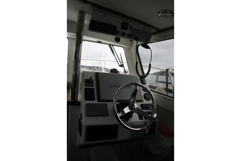 Slide: The Image of Cockpit of 2019 Ocean Sport Roamer 30 #117 with navigation equipment and steering wheel. - 12