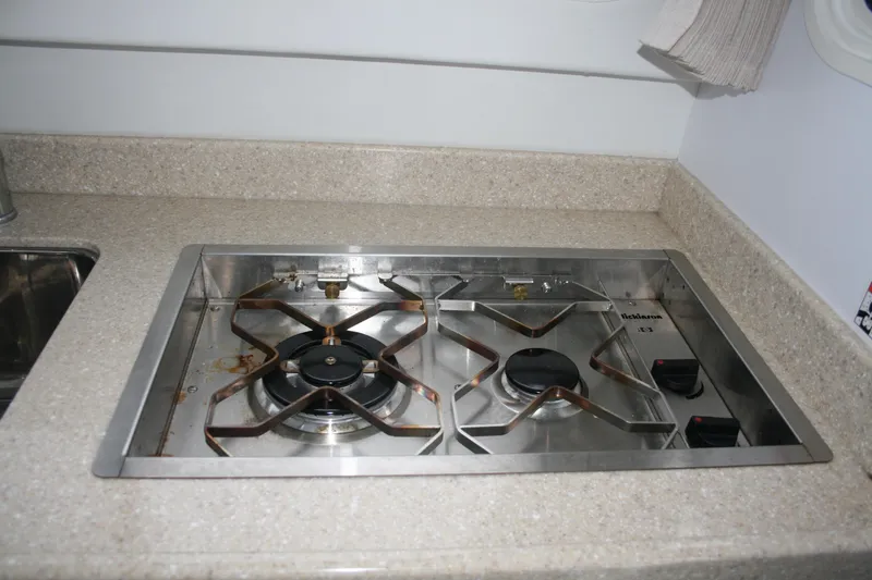 Slide: The Image of 2019 Ocean Sport Roamer 30 #117 interior with sink, countertop, and wooden cabinetry. - 18