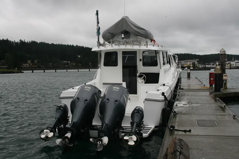 Slide: The Image of Boats docked at a marina on a cloudy day, featuring a 2019 Ocean Sport Roamer 30. - 2