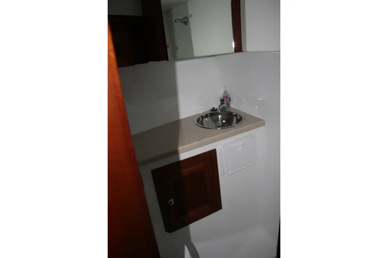 Slide: The Image of Interior of 2019 Ocean Sport Roamer 30, featuring seating and wooden cabinetry. - 20