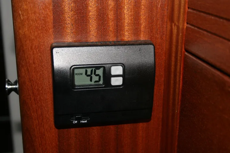 Slide: The Image of Interior of 2019 Ocean Sport Roamer 30, featuring a compact sink and wooden cabinetry. - 21