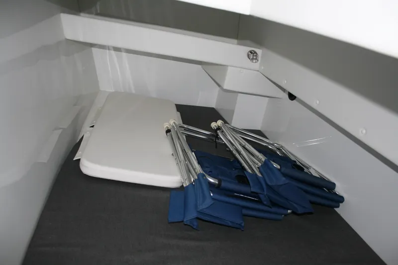 Slide: The Image of Interior of 2019 Ocean Sport Roamer 30, featuring a wooden table and cushioned seating. - 26