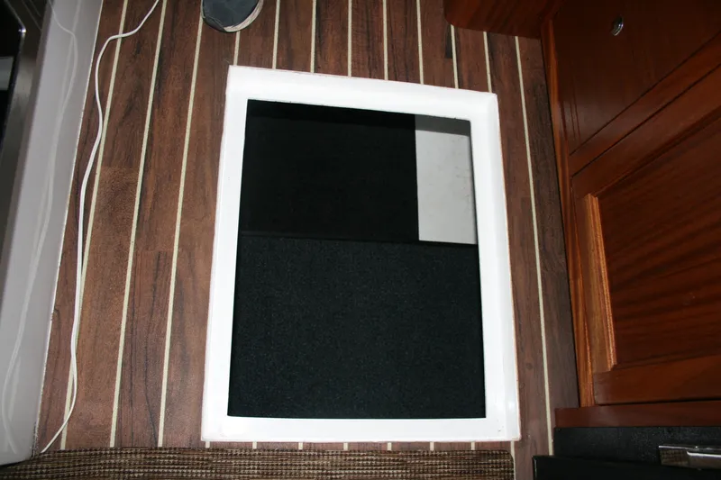 Slide: The Image of Interior storage area of 2019 Ocean Sport Roamer 30, featuring folded chairs and a table. - 27