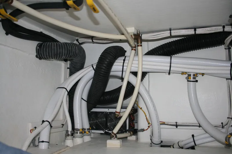 Slide: The Image of Engine room of 2019 Ocean Sport Roamer 30, showcasing plumbing and wiring systems. - 34
