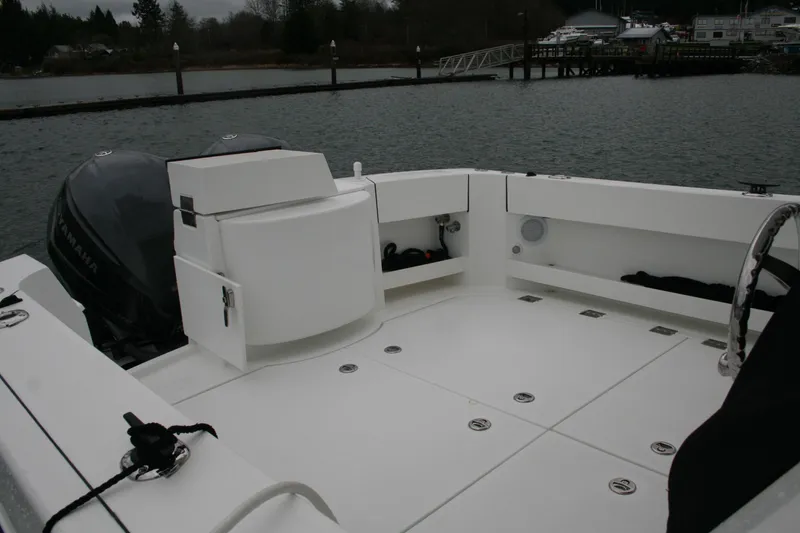 Slide: The Image of 2019 Ocean Sport Roamer 30 boat with Garmin equipment, docked near a marina. - 7