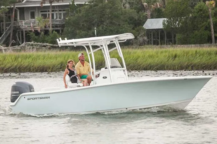 Slide: The Image of Manufacturer Provided Image: 2016 Sportsman Open 212 Center Console boat cruising on water with two passengers. - 4