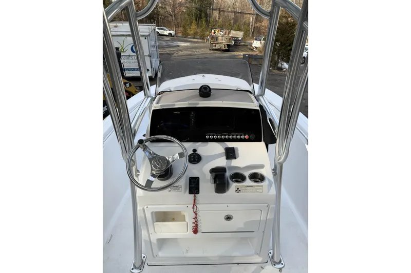 Slide: The Image of 2016 Sportsman Open 212 Center Console boat dashboard with steering wheel and controls. - 8