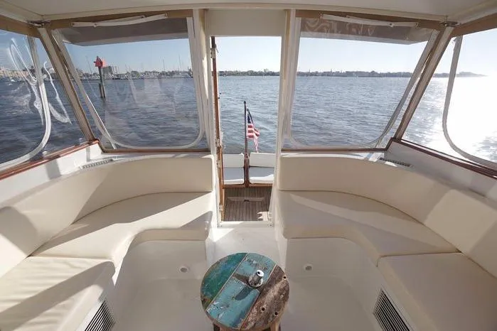 Slide: The Image of Interior view of 2003 Huckins Atlantic 44 yacht with waterfront backdrop. - 12