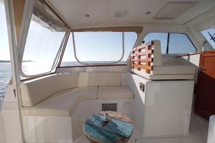 Slide: The Image of Interior of 2003 Huckins Atlantic 44 yacht with seating and ocean view. - 13