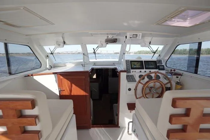 Slide: The Image of Interior view of 2003 Huckins Atlantic 44 yacht, featuring helm and seating area. - 16