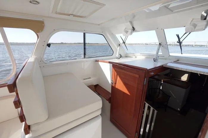 Slide: The Image of Interior view of 2003 Huckins Atlantic 44 yacht with seating and water view. - 17