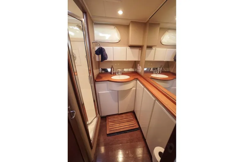 Slide: The Image of Luxurious bathroom interior of 2003 Huckins Atlantic 44 yacht with wooden accents. - 31