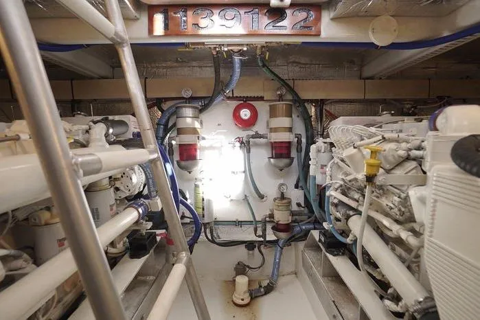 Slide: The Image of Engine room of 2003 Huckins Atlantic 44 yacht, showcasing machinery and equipment. - 35