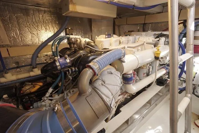 Slide: The Image of Engine room of 2003 Huckins Atlantic 44 yacht, showcasing complex machinery and piping. - 36