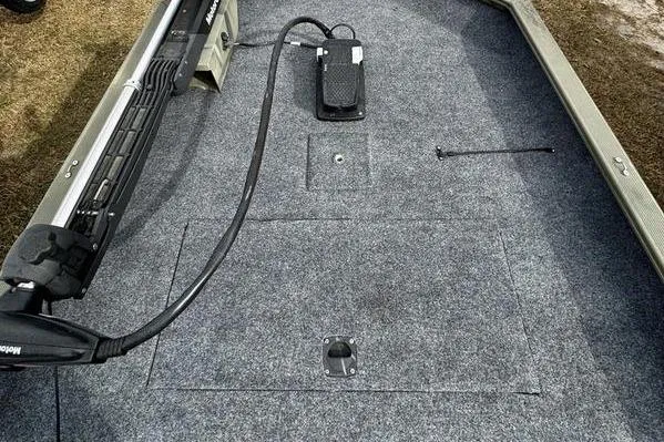 Slide: The Image of 2007 Tracker Grizzly 1654 SC boat interior with carpeted deck and trolling motor. - 6