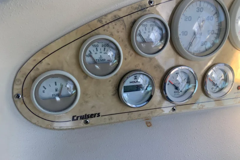 Slide: The Image of Instrument panel of a 1998 Cruisers 3375 Espirit boat, showing various gauges. - 12