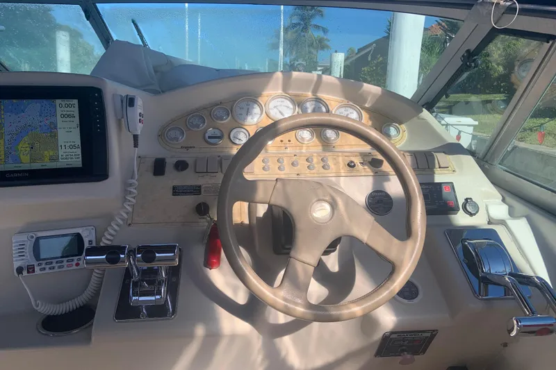 Slide: The Image of 1998 Cruisers 3375 Espirit boat dashboard with steering wheel and navigation equipment. - 16