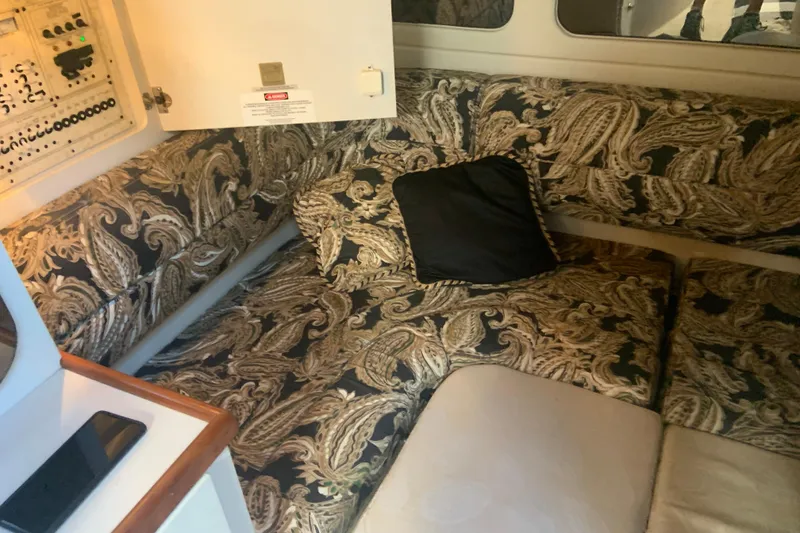 Slide: The Image of 1998 Cruisers 3375 Espirit cabin interior with patterned upholstery and control panel. - 23