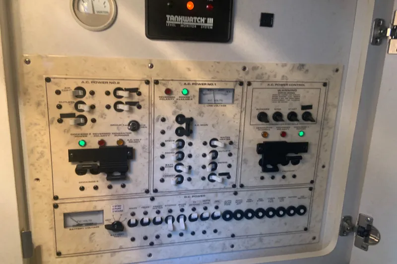 Slide: The Image of Control panel of a 1998 Cruisers 3375 Espirit boat, featuring various switches and gauges. - 28
